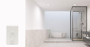 Bathroom lit by downlights with switch and dimmer panel in foreground