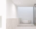 Bathroom lit by downlights with switch and dimmer panel in foreground